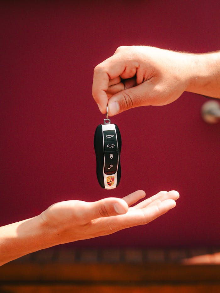 pexels-photo-28353829 Close-up of hands exchanging a luxury car key in São Paulo, Brazil.